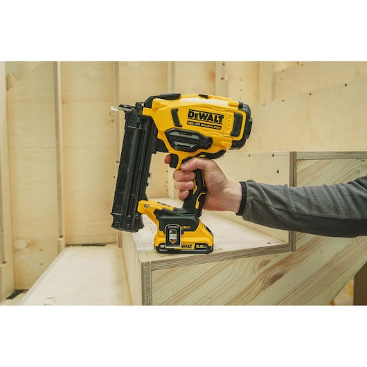 DEWALT nailer in use on wood. Shown SKUs: BSV520BRB, DCN210SN-XJ. Photography product category.