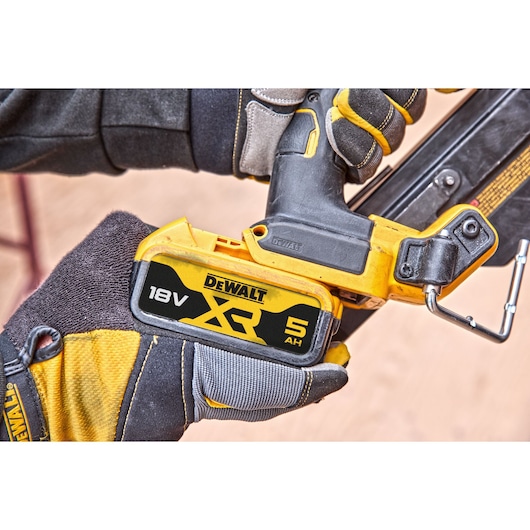 5Ah 18V XR battery being attached to a DCN930 18V XR Brushless framing nailer 