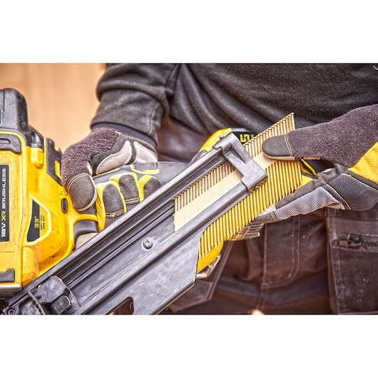	Nail magazine being loaded into a DCN930 18V XR Brushless framing nailer 