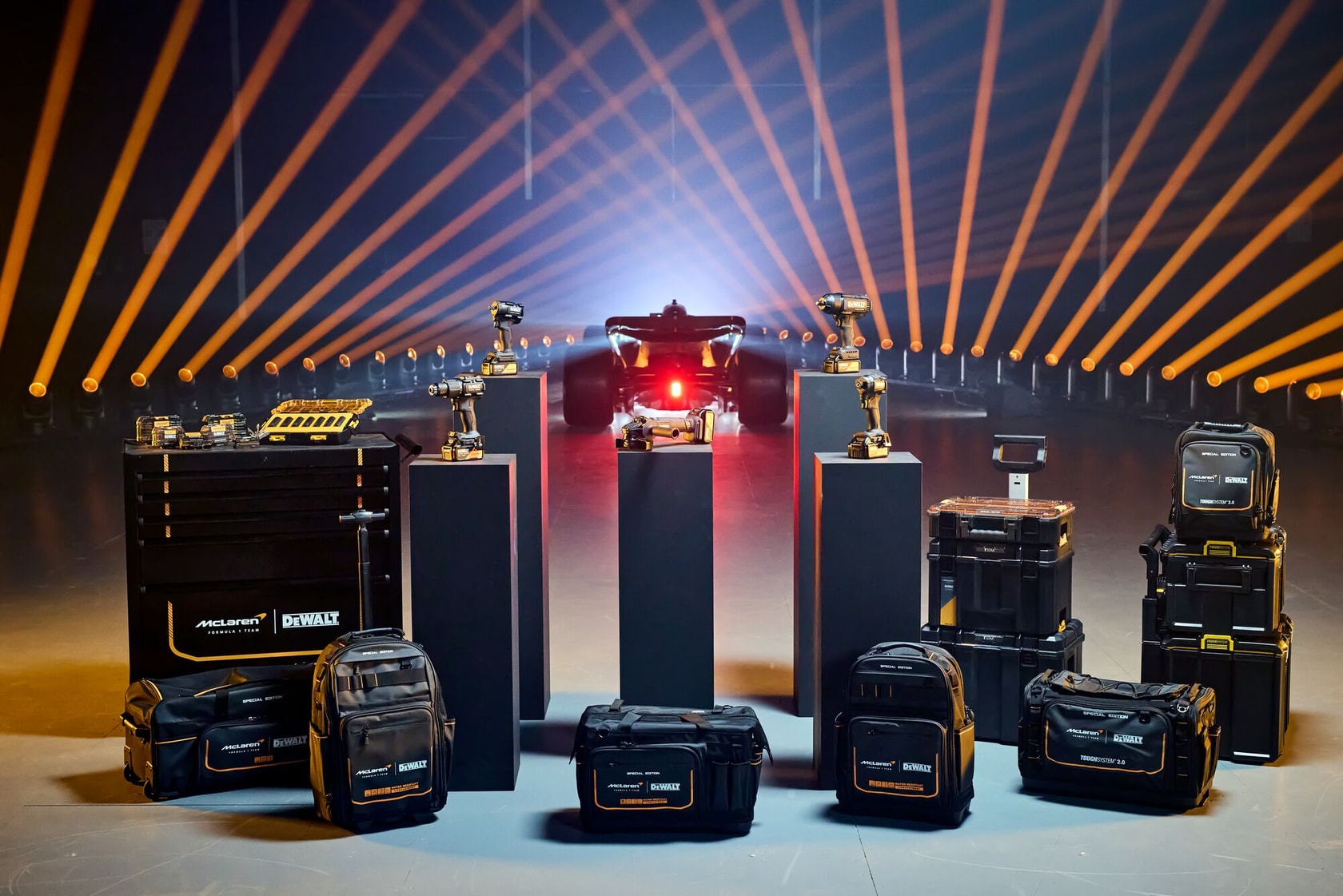 DEWALT photography kit DCD86MP2T-QW, DCD86MP2T with cases, tools, bags, and car in a studio with orange lights.